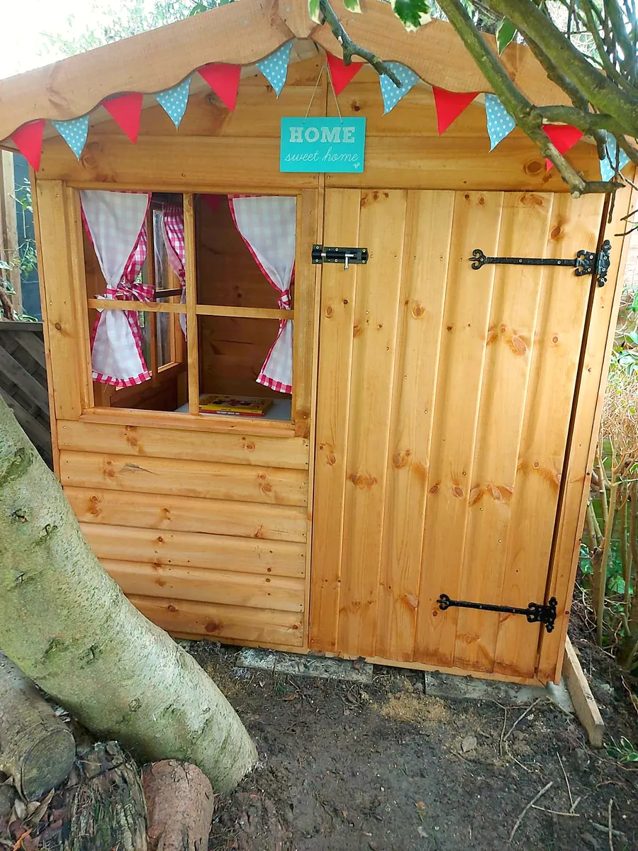 Children's playhouse with bunting, curtains and a stable door