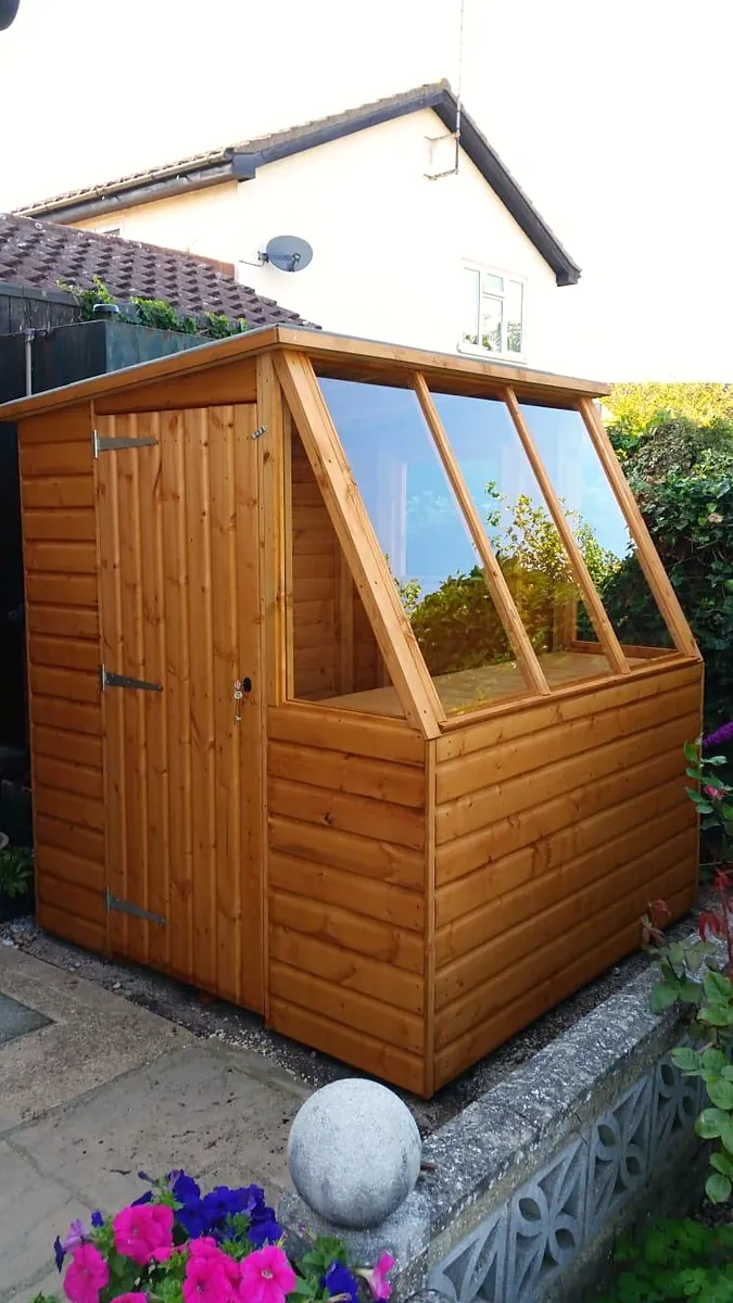 Garden potting shed with a glazed sloping roof