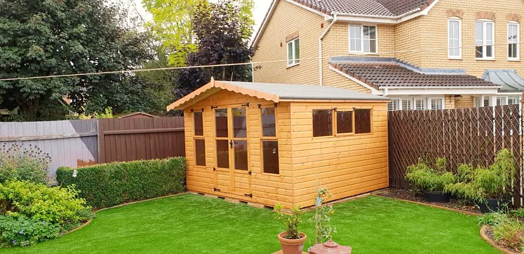 Apex roof summer house with double doors and a path