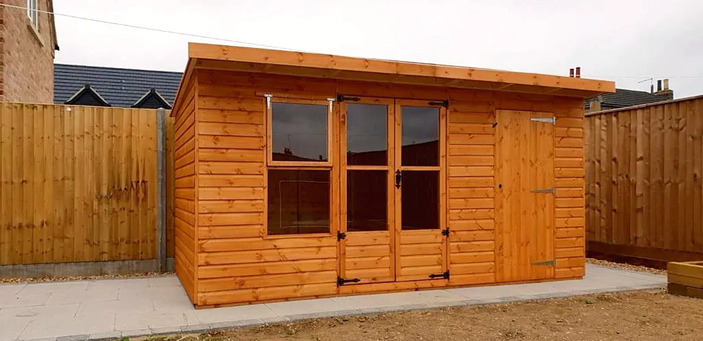 Pent roof summer house in a sunny garden