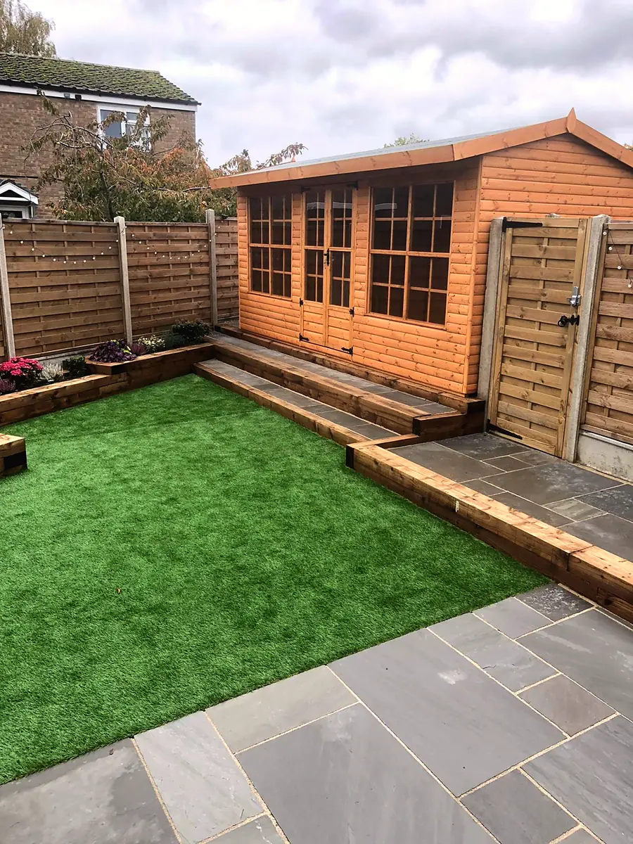 Pent roof summer house set into a garden corner