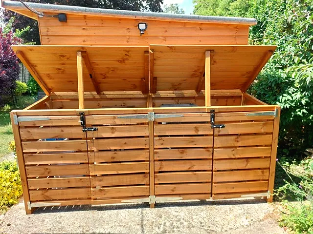 Garden bin storage unit with doors and lids open