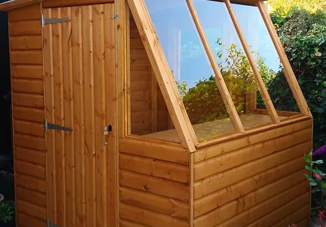 Garden potting shed with a glazed sloping roof